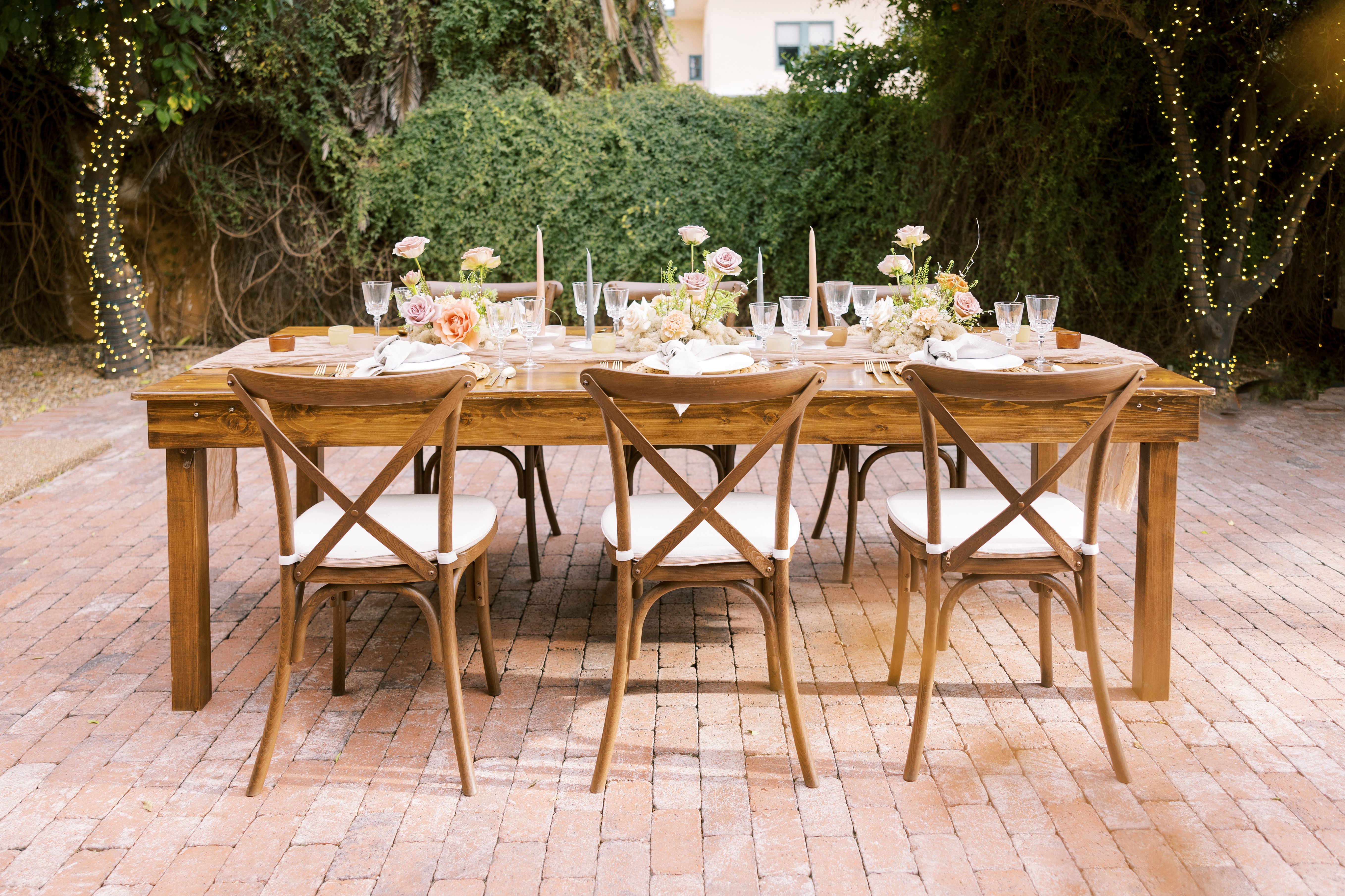 Wooden Tables and Chairs with Flowers and Dishware